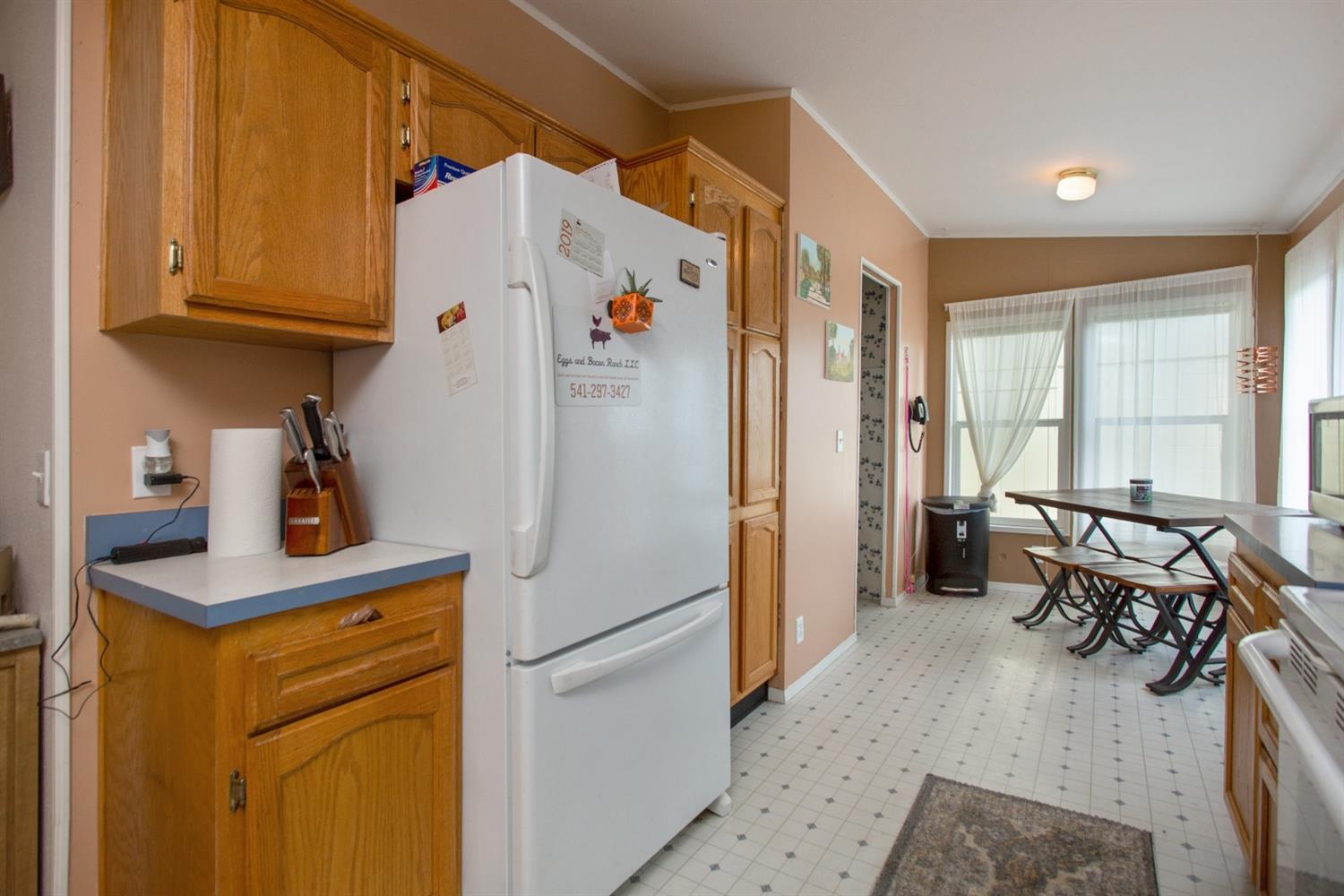 940 Ayres Road Eagle Point, OR 97524 - Photo 12 of 35 a kitchen with refrigerator and window