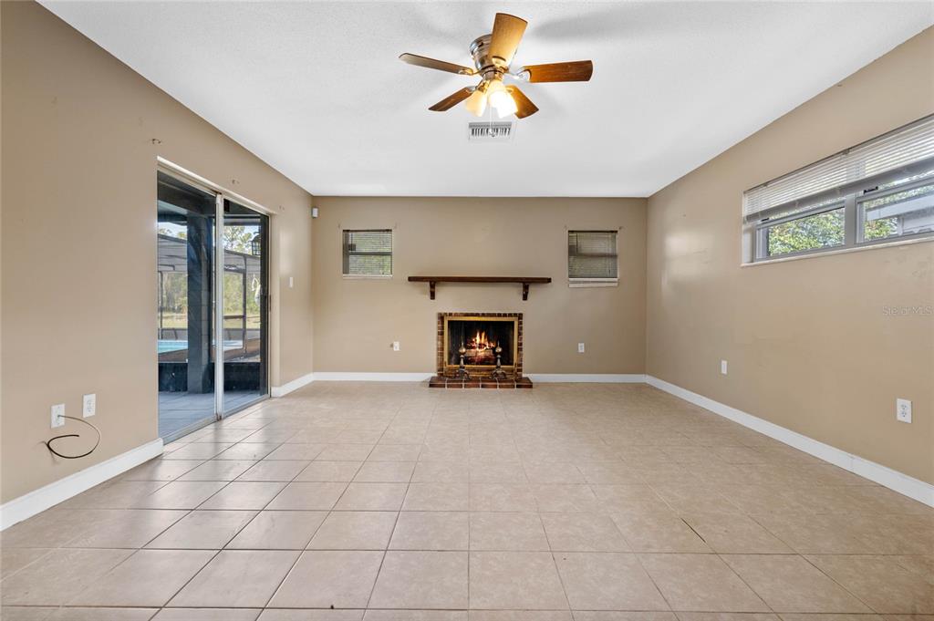 1033 Shore Acres Road Mount Dora, FL 32757 - Photo 16 of 48 Master bedroom with fireplace and sliders out to the pool area.