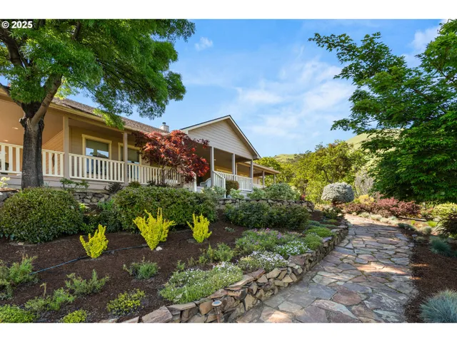 a front view of a house with a garden