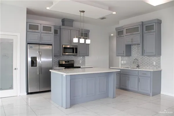 a kitchen with a sink stainless steel appliances and cabinets