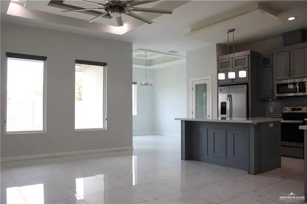 a kitchen with stainless steel appliances granite countertop a sink and a stove