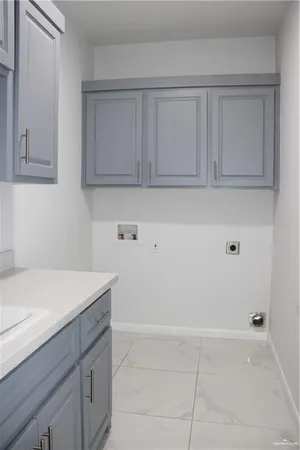 a view of kitchen with white cabinets