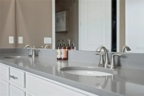 a bathroom with a granite countertop sink and a bathtub