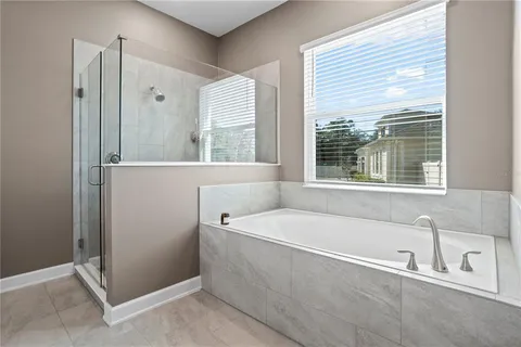 a bathroom with a bathtub and shower