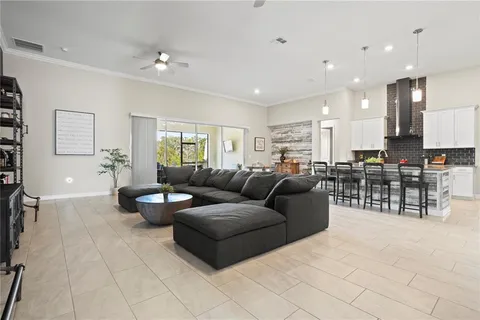 a living room with furniture and kitchen view