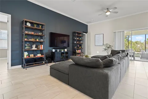 a living room with furniture a rug and a book shelf