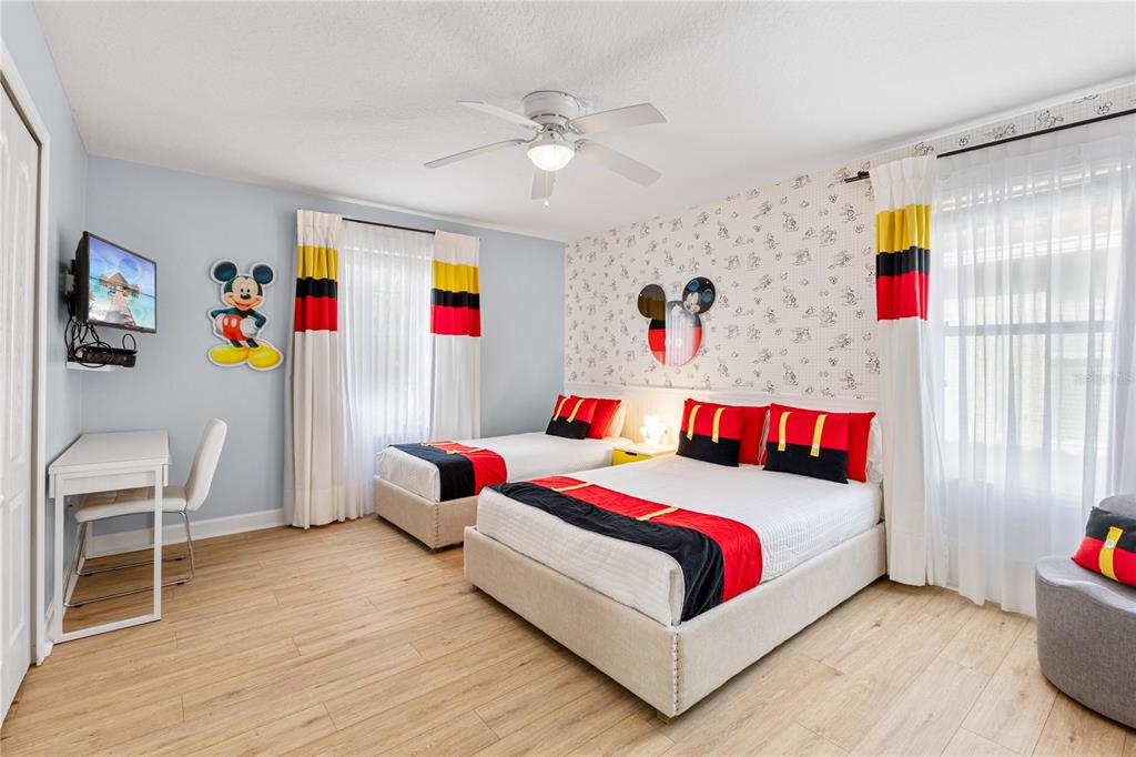 9006 Majesty Palm Road Kissimmee, FL 34747 - Photo 51 of 56 a bedroom with a bed and a couch