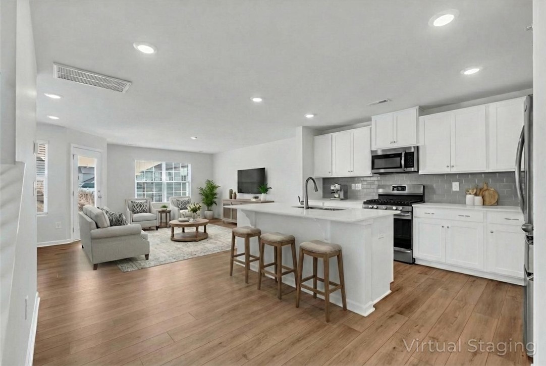 515 Brasstown Court Pendleton, SC 29670 - Photo 4 of 25 Virtually staged, this bright open-concept space features a beautiful kitchen island and inviting living area.