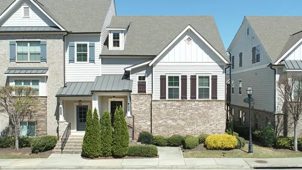 a view of a brick house with many windows