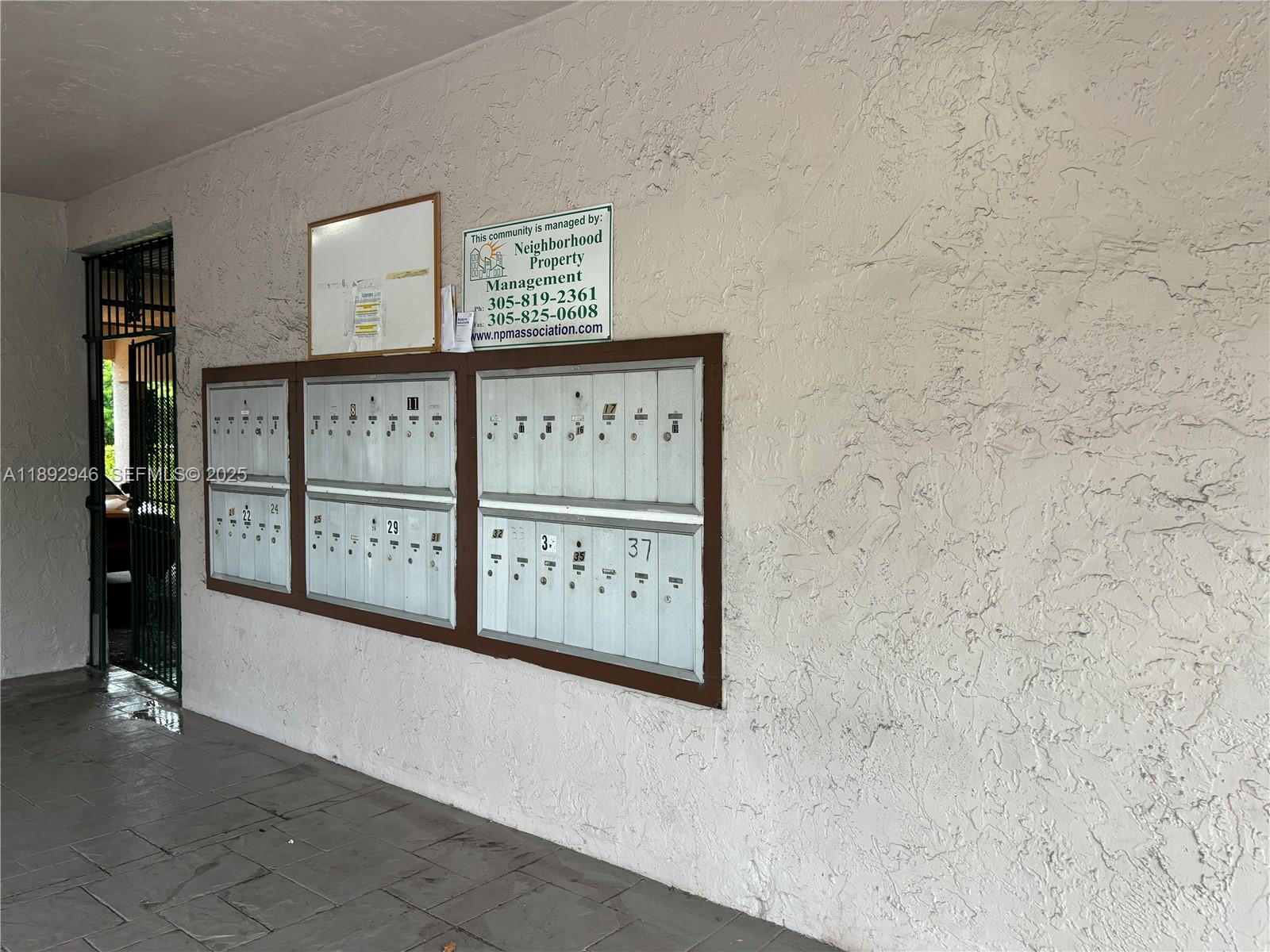 1350 West 53rd Street, Unit 24 Hialeah, FL 33012 - Photo 12 of 32 a view of a hallway with paintings on the wall