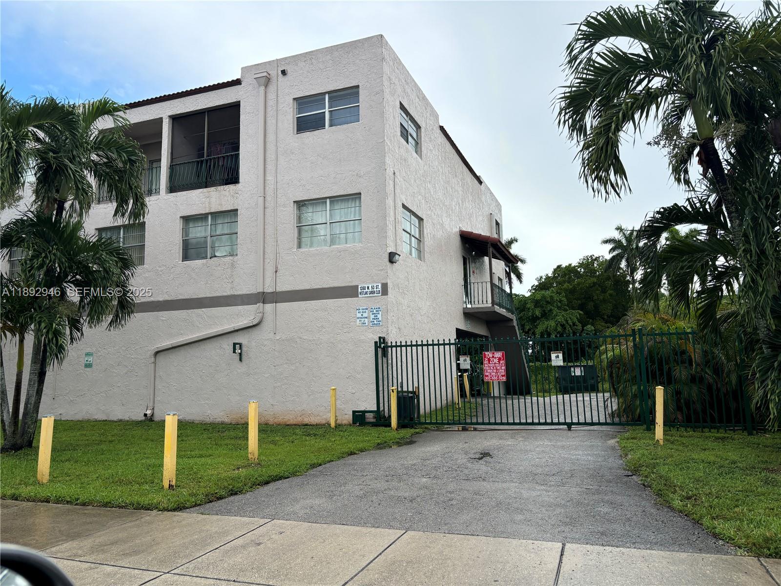 1350 West 53rd Street, Unit 24 Hialeah, FL 33012 - Photo 13 of 32 a view of a house with a yard and palm trees