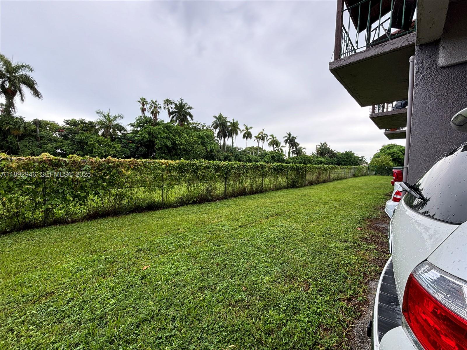 1350 West 53rd Street, Unit 24 Hialeah, FL 33012 - Photo 17 of 32 a view of a backyard with plants and a garden