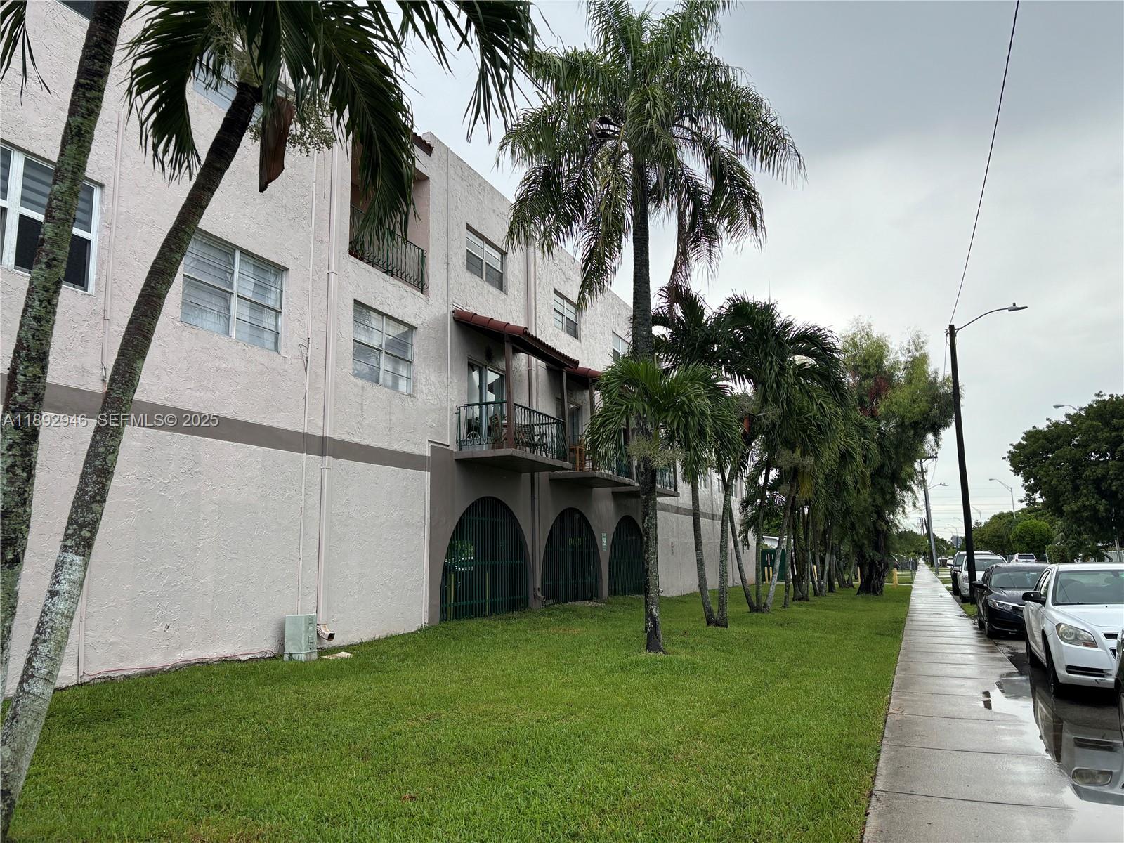 1350 West 53rd Street, Unit 24 Hialeah, FL 33012 - Photo 2 of 32 a view of a backyard with potted plants and palm trees