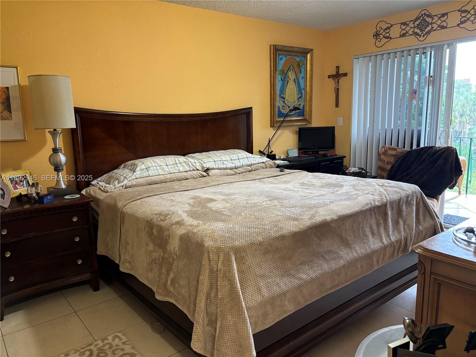 1350 West 53rd Street, Unit 24 Hialeah, FL 33012 - Photo 21 of 32 a bedroom with a bed and wooden floor