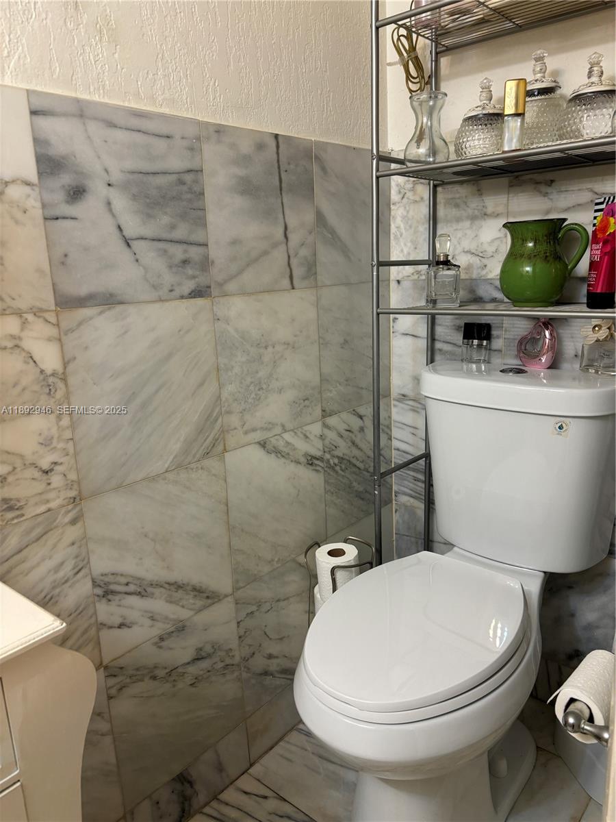 1350 West 53rd Street, Unit 24 Hialeah, FL 33012 - Photo 28 of 32 a bathroom with a toilet and a sink