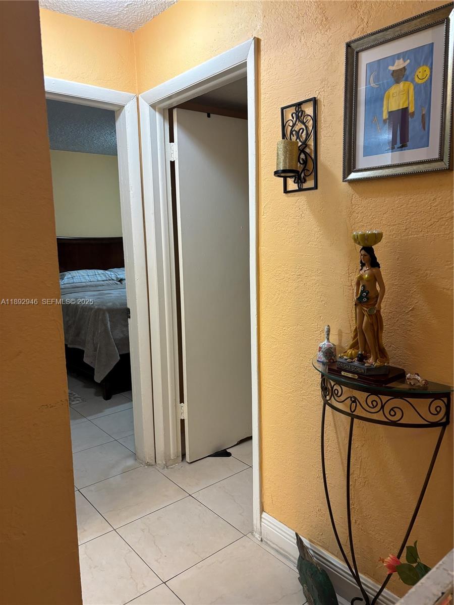1350 West 53rd Street, Unit 24 Hialeah, FL 33012 - Photo 31 of 32 a view of a hallway with a room