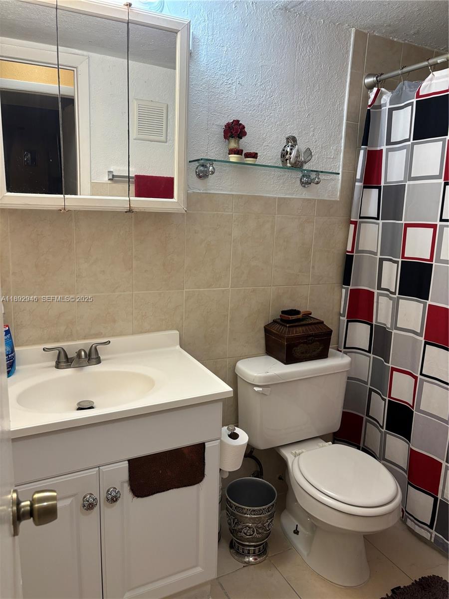 1350 West 53rd Street, Unit 24 Hialeah, FL 33012 - Photo 32 of 32 a bathroom with a sink and a toilet