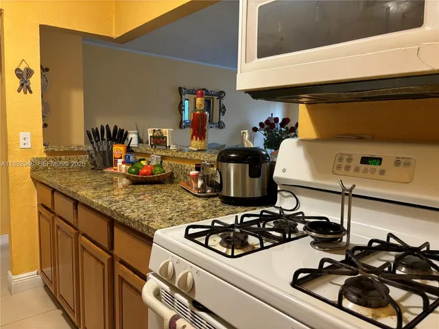 a kitchen with a stove and a white cabinets