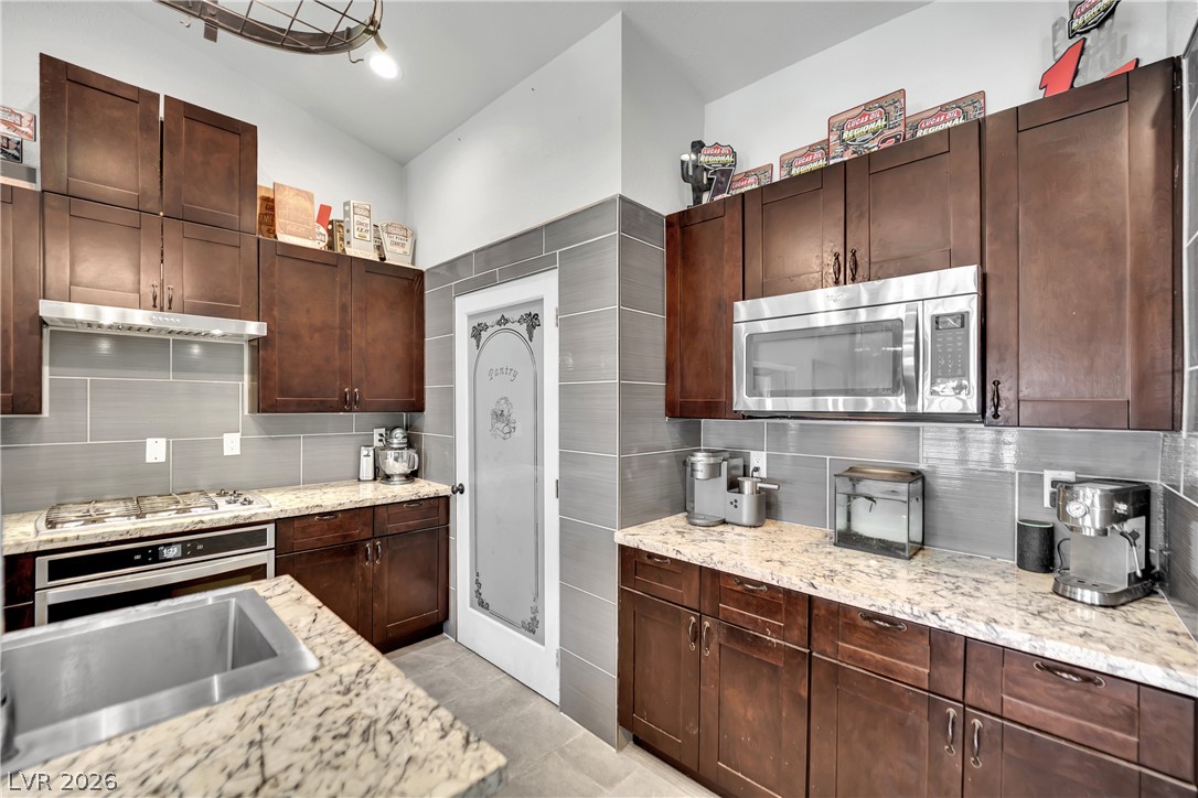 420 North Racetrack Road Henderson, NV 89015 - Photo 20 of 52 Culinary delights await in this modern kitchen with rich cabinetry and durable countertops.