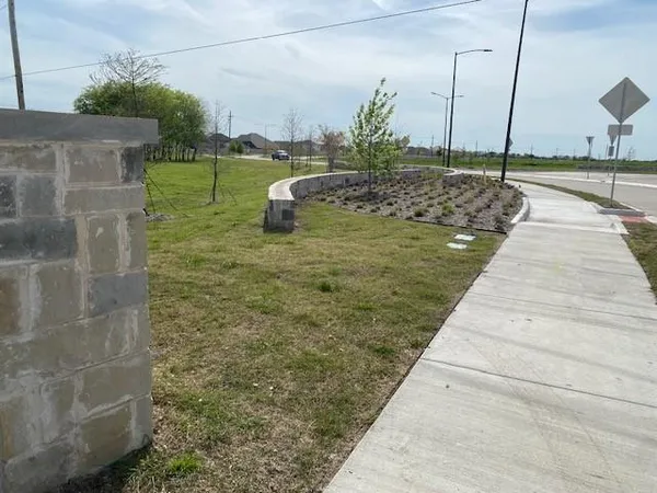 a view of a tall building next to a yard