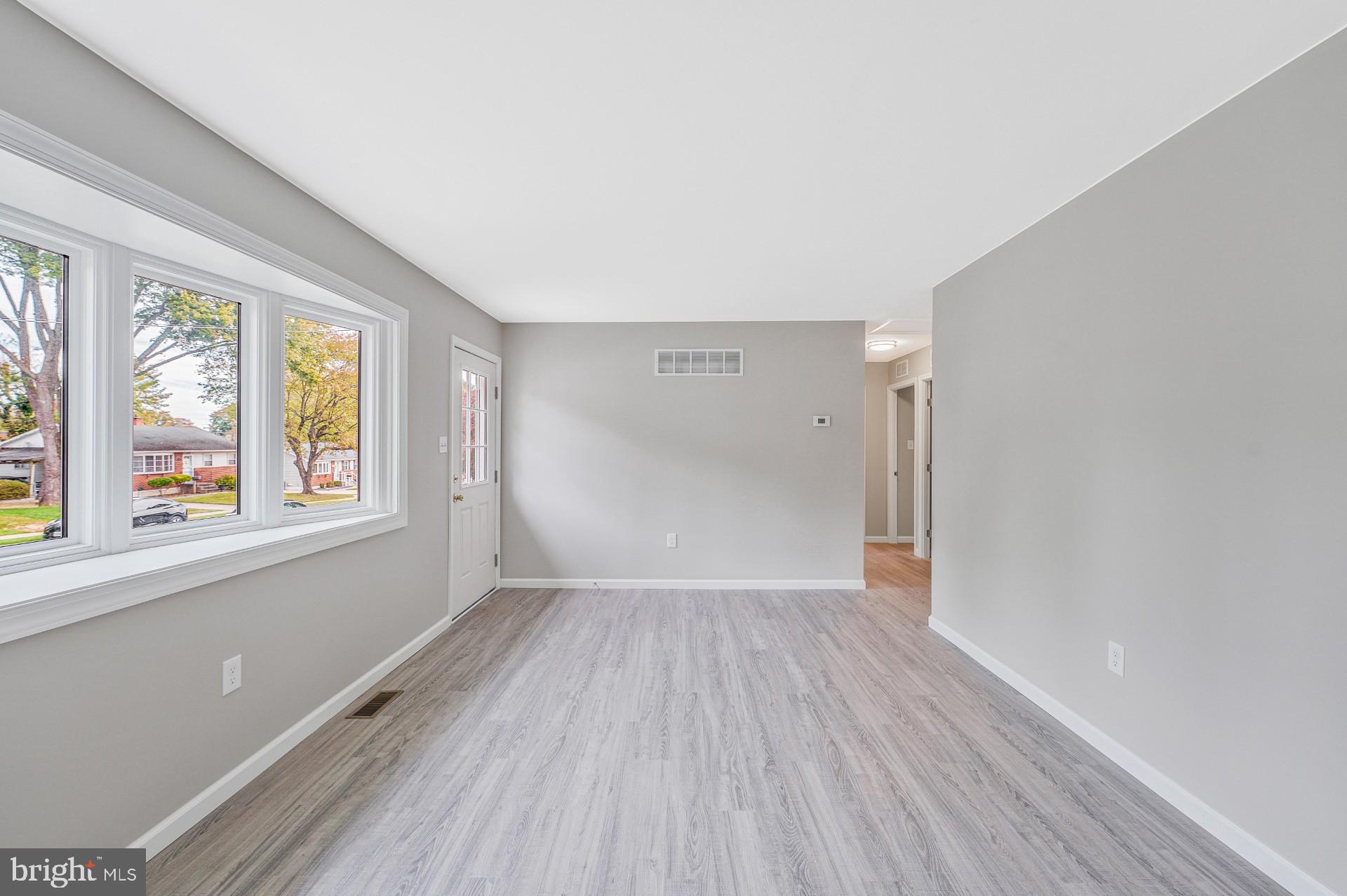 237 Candytuft Road Reisterstown, MD 21136 - Photo 13 of 34 a view of an empty room with wooden floor and a window