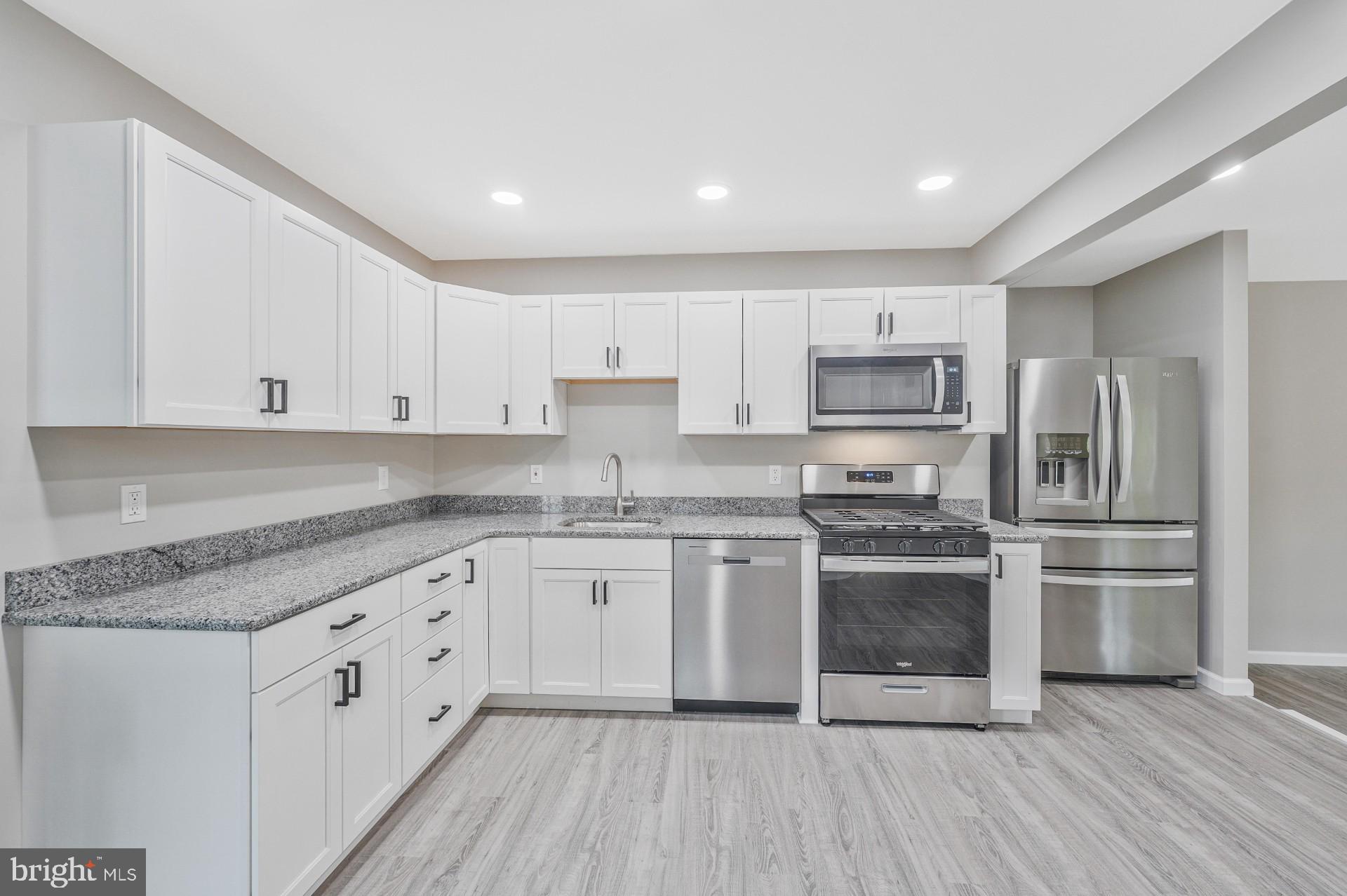237 Candytuft Road Reisterstown, MD 21136 - Photo 16 of 34 a kitchen with stainless steel appliances granite countertop a stove a sink and white cabinets