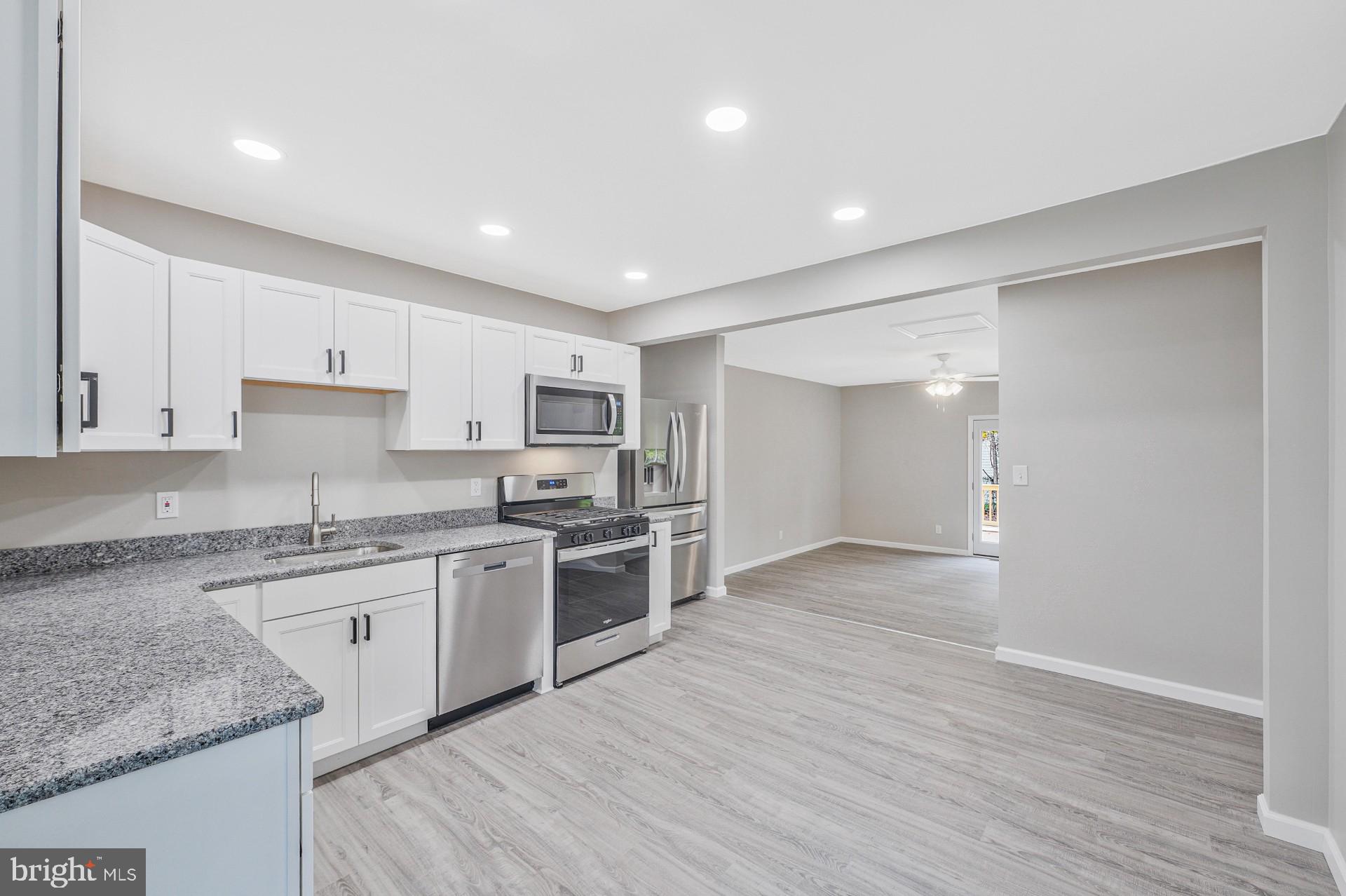 237 Candytuft Road Reisterstown, MD 21136 - Photo 17 of 34 a large kitchen with stainless steel appliances granite countertop a stove and a sink