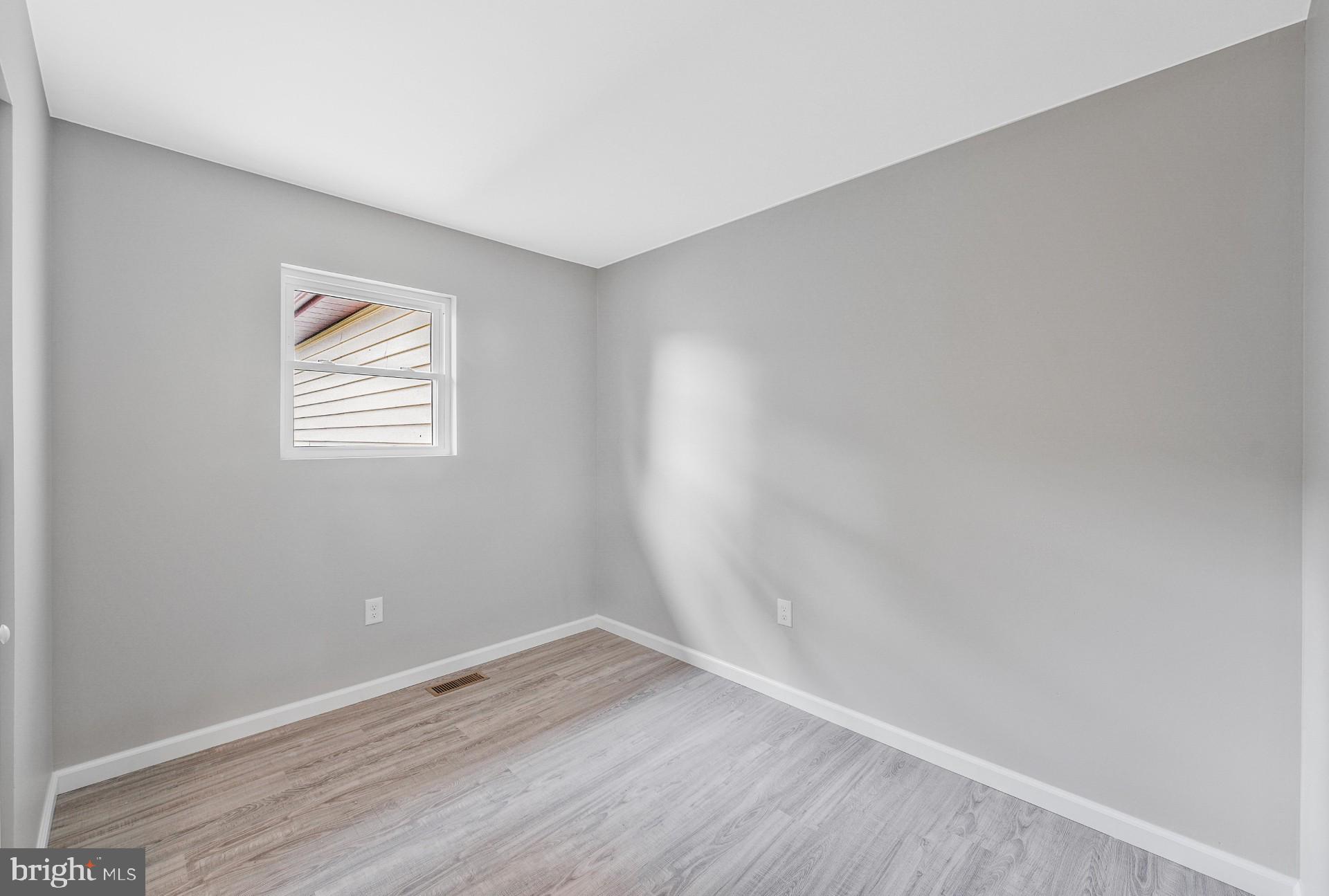 237 Candytuft Road Reisterstown, MD 21136 - Photo 30 of 34 an empty room with wooden floor and windows