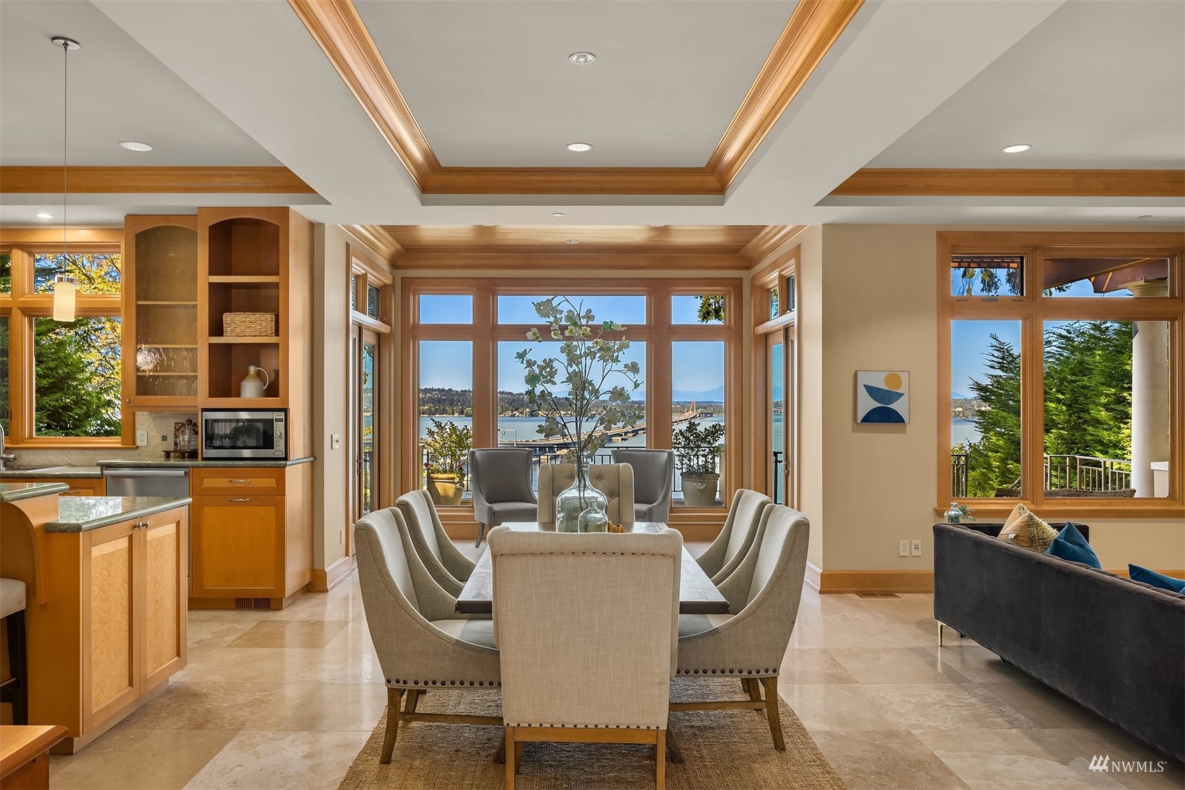 3235 Evergreen Point Road Medina, WA 98039 - Photo 7 of 39 a dining room with furniture a water fountain and large windows