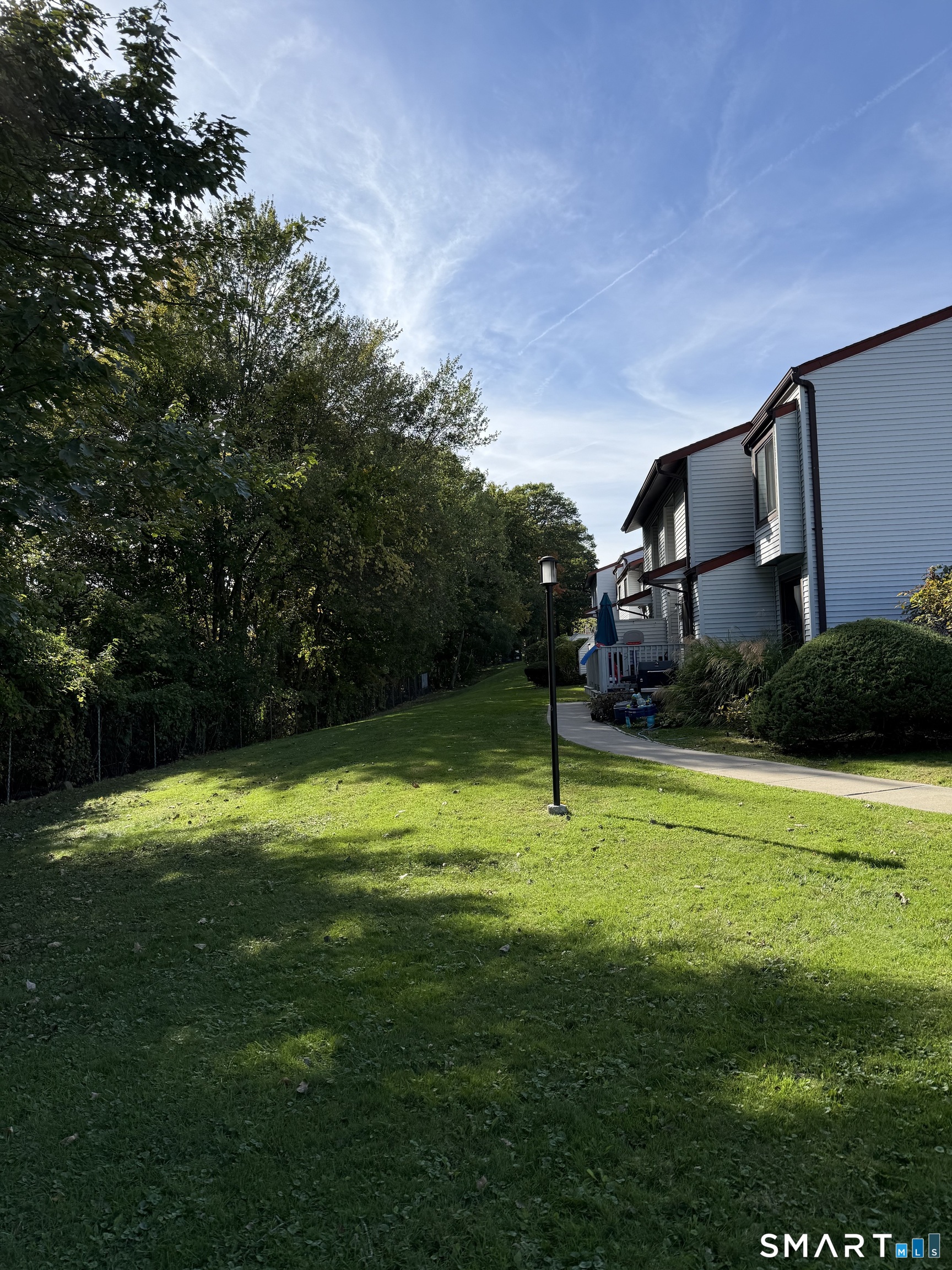 221 Cottonwood Road, Unit 221 Newington, CT 06111 - Photo 1 of 26 a backyard with a garden and entertaining space