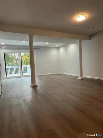 a view of an empty room with wooden floor
