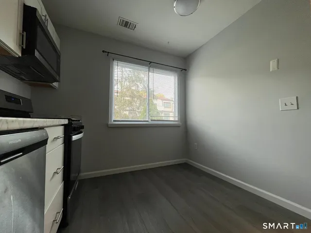 a room with wooden floor and a window