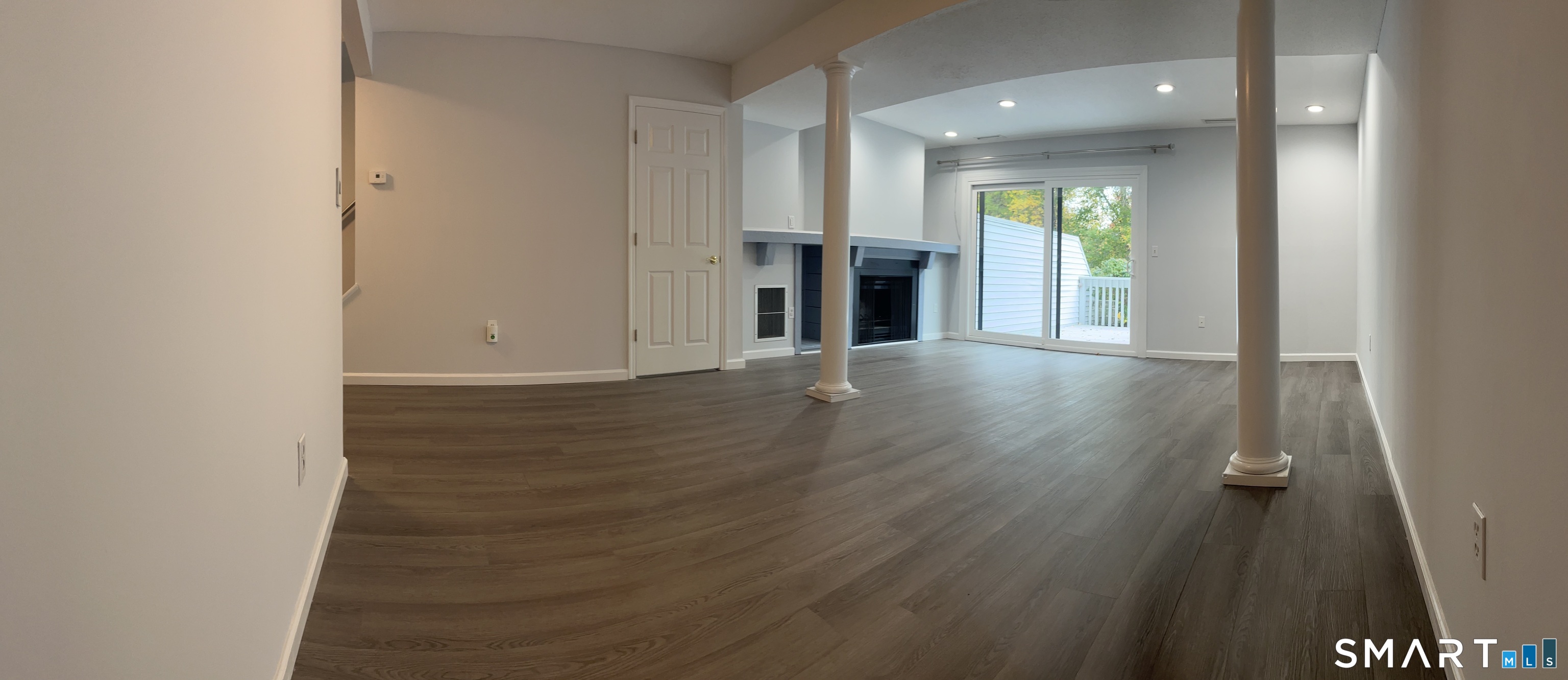 221 Cottonwood Road, Unit 221 Newington, CT 06111 - Photo 6 of 26 an empty room with wooden floor and windows