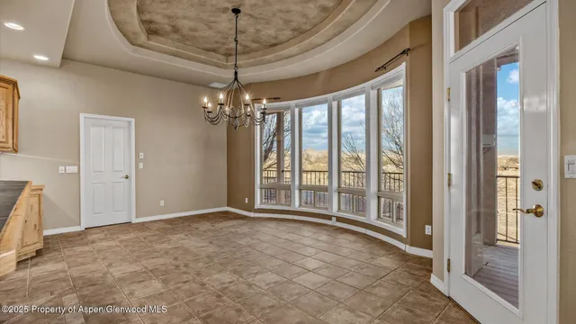 a view of an empty room with a chandelier