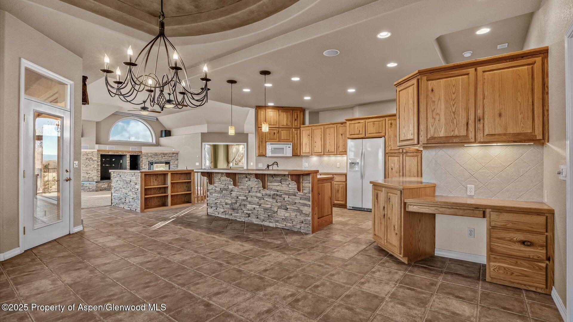 2426 H Road Grand Junction, CO 81505 - Photo 13 of 39 a large kitchen with kitchen island a large counter top stainless steel appliances and cabinets