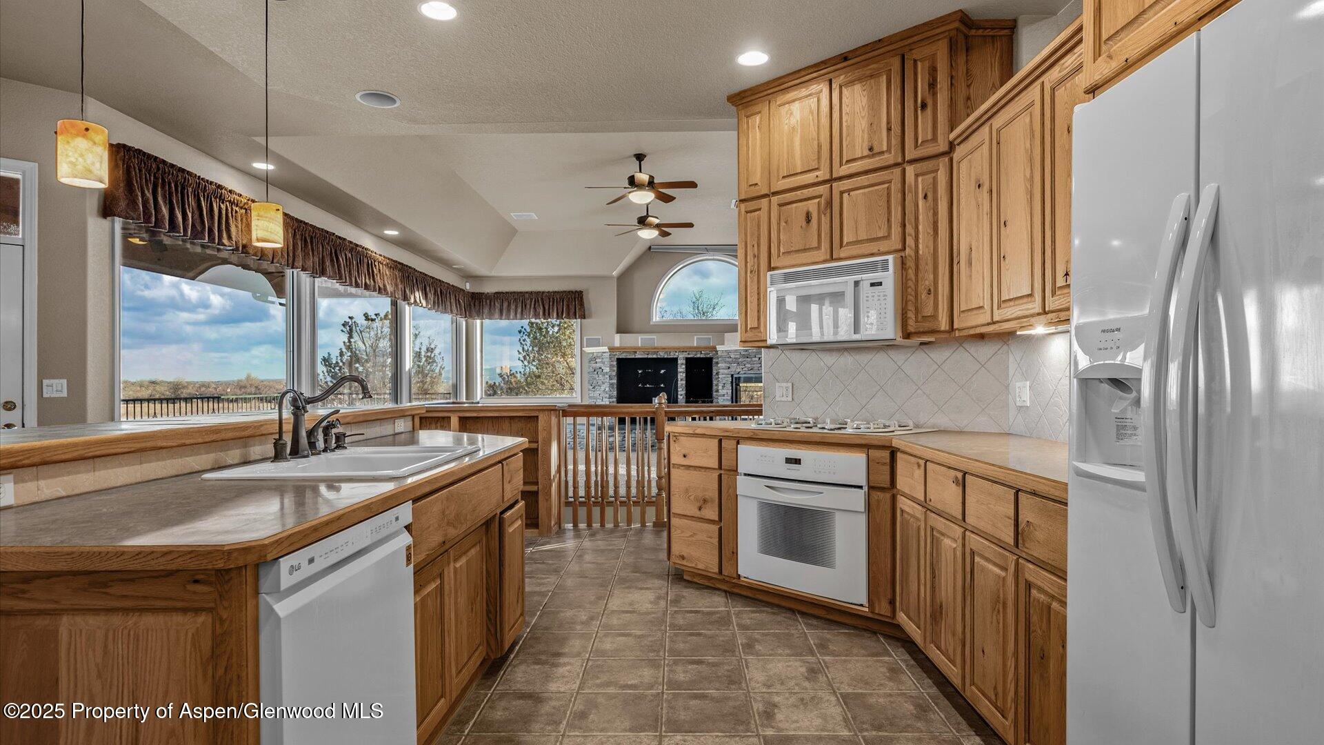 2426 H Road Grand Junction, CO 81505 - Photo 14 of 39 a kitchen with stainless steel appliances granite countertop a sink a stove and a refrigerator