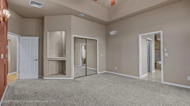 an empty room with closet and a bathroom
