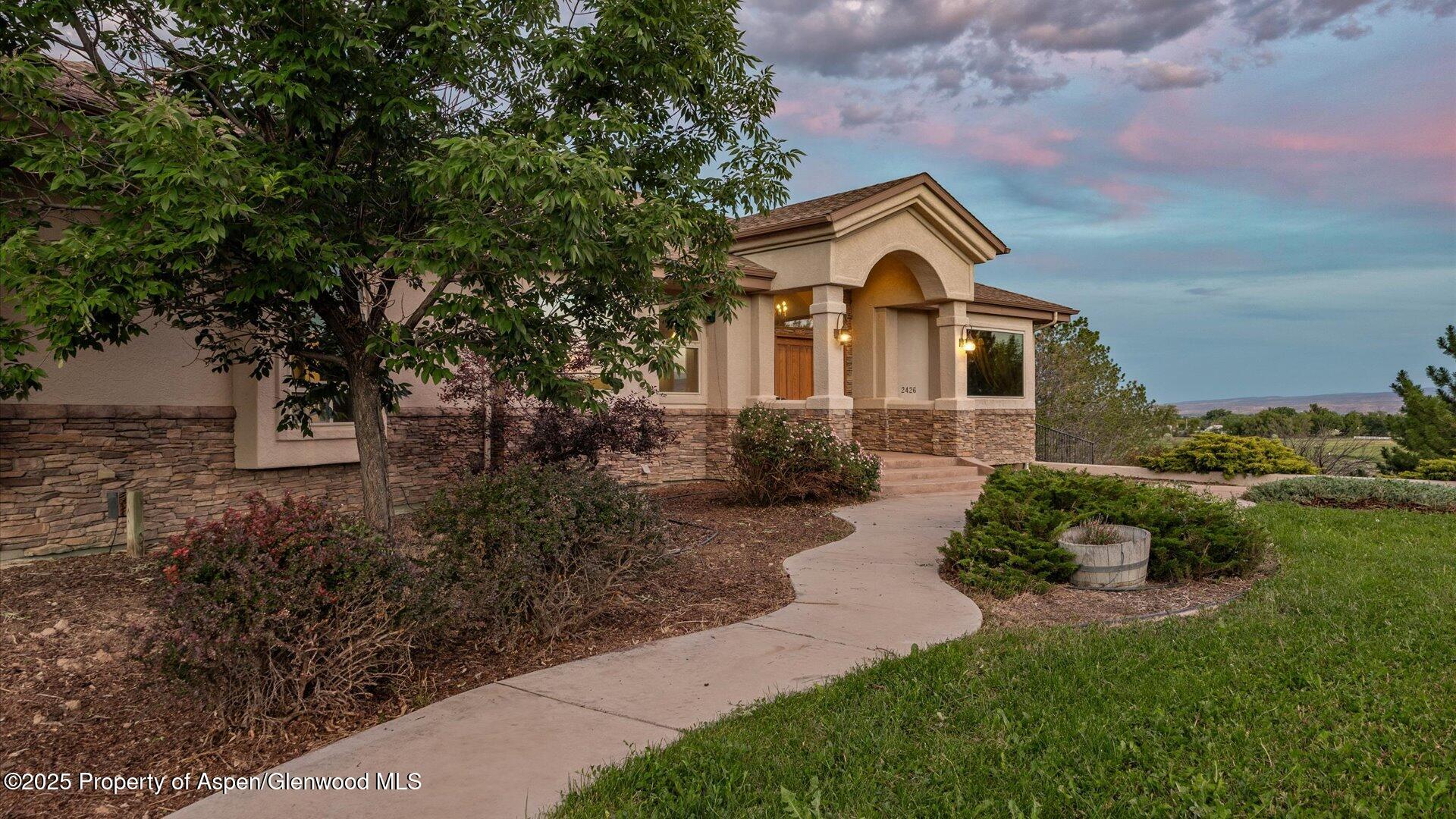 2426 H Road Grand Junction, CO 81505 - Photo 2 of 39 a front view of a house with yard and trees