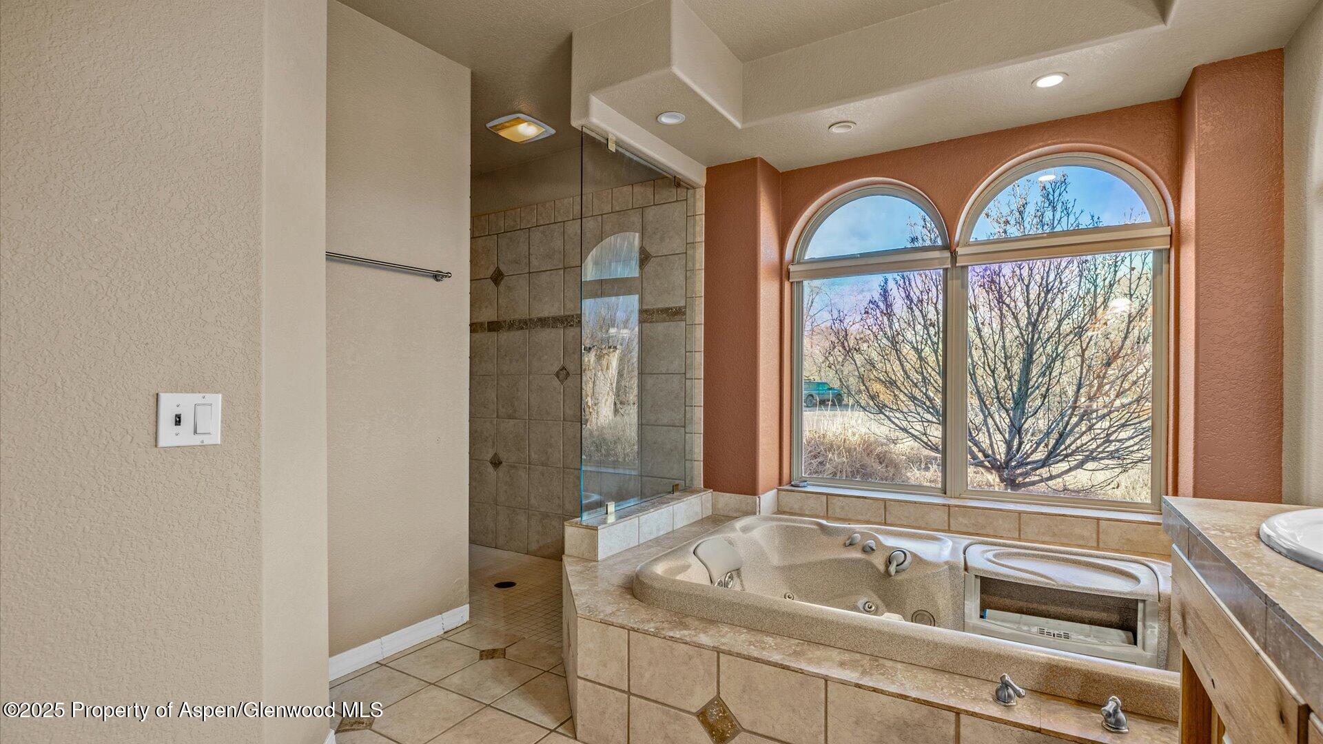 2426 H Road Grand Junction, CO 81505 - Photo 21 of 39 a bathroom with a tub a sink and a large window