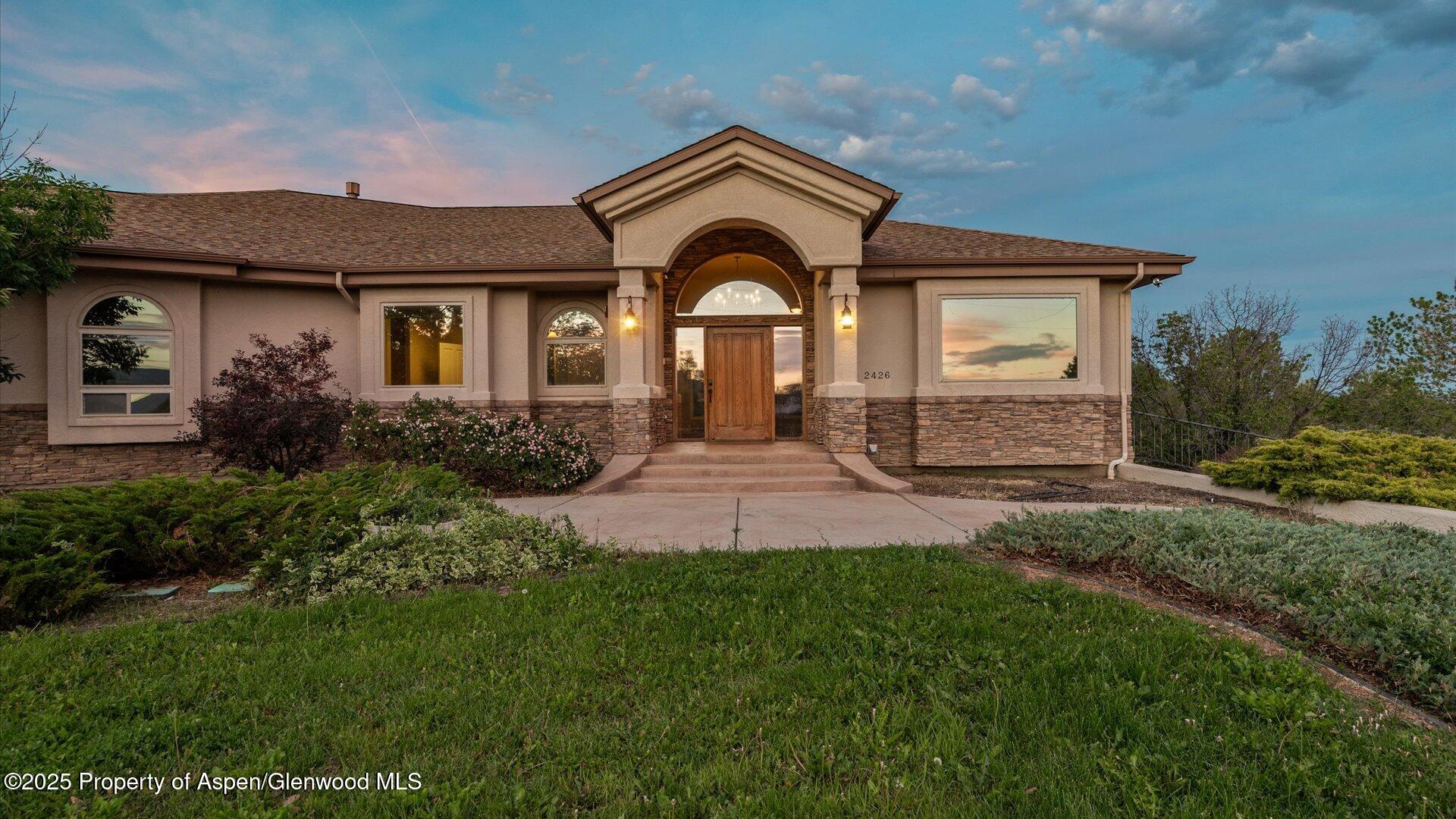 2426 H Road Grand Junction, CO 81505 - Photo 3 of 39 a front view of a house with a yard