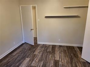 5728 Rockhill Road Fort Worth, TX 76112 - Photo 12 of 38 a view of an empty room with wooden floor and a window
