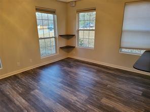 5728 Rockhill Road Fort Worth, TX 76112 - Photo 16 of 38 an empty room with wooden floor and windows