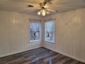 5728 Rockhill Road Fort Worth, TX 76112 - Photo 2 of 38 a view of an empty room with window and wooden floor