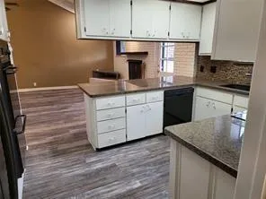 a kitchen with granite countertop a sink and a stove