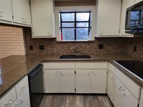 5728 Rockhill Road Fort Worth, TX 76112 - Photo 31 of 38 a kitchen with granite countertop white cabinets white stainless steel appliances and a sink