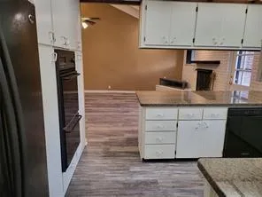 a kitchen with a refrigerator and cabinets