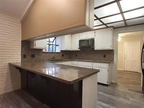 5728 Rockhill Road Fort Worth, TX 76112 - Photo 36 of 38 a kitchen with stainless steel appliances granite countertop a sink stove and cabinets