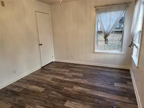 5728 Rockhill Road Fort Worth, TX 76112 - Photo 4 of 38 an empty room with wooden floor and window