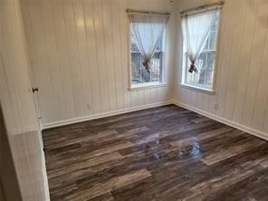 5728 Rockhill Road Fort Worth, TX 76112 - Photo 5 of 38 a view of an empty room with window and wooden floor