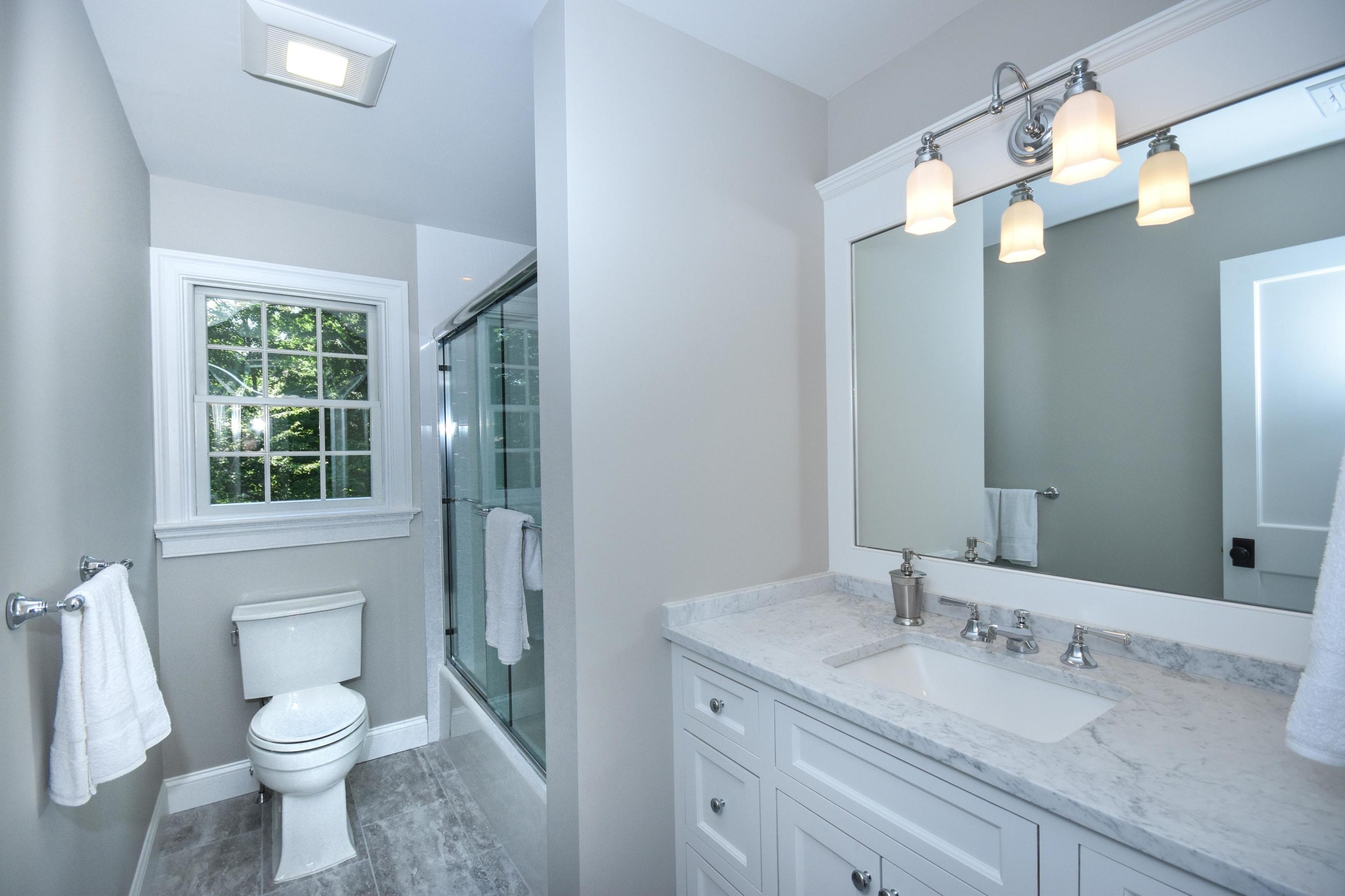 29 Brookside Road Darien, CT 06820 - Photo 17 of 26 a bathroom with a granite countertop toilet sink and mirror